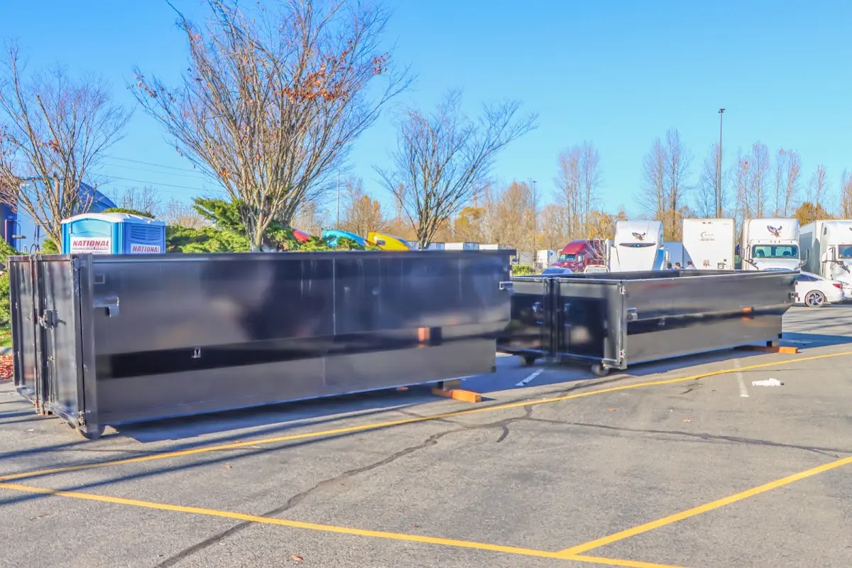 Professional dumpster rental service with roll-off container on residential driveway in Riverside